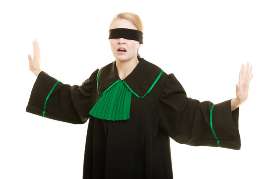 Blind justice. Woman covering eyes with blindfold