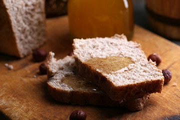 Fresh bread with honey on wooden background