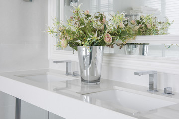 modern wash basin with  counter and vase of flower