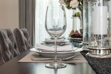 empty wine glass on wooden dinning table with table set