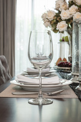 empty wine glass on wooden dinning table with table set