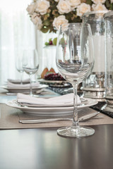 empty wine glass on wooden dinning table with table set