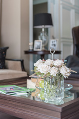 glass vase of flower on wooden table in living room
