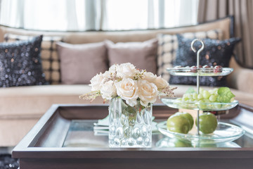 Fototapeta na wymiar glass vase of flower on wooden table in living room
