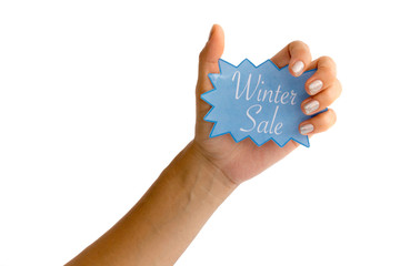 Woman's hand with silver fingernails holding a blue winter sale