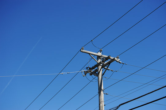 electricity pole against blue sky