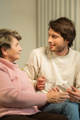 Senior woman talking with caregiver