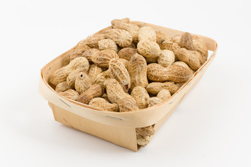 wooden container is filled with a peanut on a white background