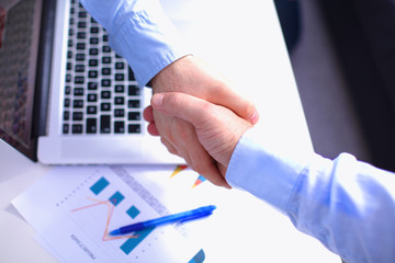 Business handshake. Two businessman shaking hands with each other in the office