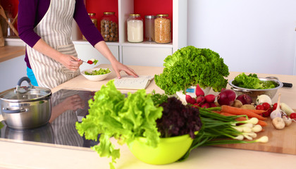 Young Woman Cooking in the kitchen. Healthy Food