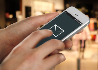 Hands holding mobile smart phone on abstract background