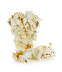Glass bowl with popcorn on white background