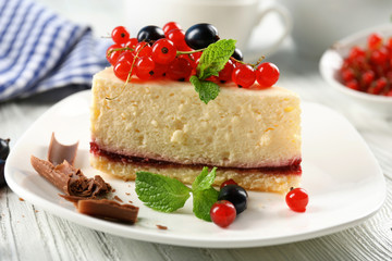 Delicious cheesecake with berries on table close up