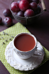 Delicious plum juice with fruits on wooden table close up