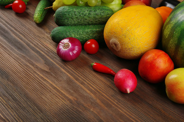 Heap of fruits and vegetables on wooden background