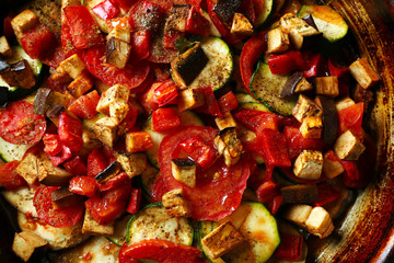 Tasty vegetarian ratatouille in black cast iron pan, close-up