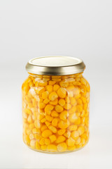Sweet corn in glass jar isolated on white