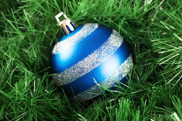 Fancy christmas ball with decoration isolated on grass