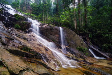 Fototapeta na wymiar Beautiful cascading waterfall in tropical forest