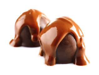 Chocolate poured on candy isolated on white