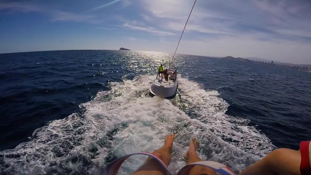 Parasailing flying over the beach of Benidorm city.