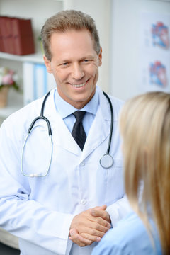 Professional doctor talking with his patient  