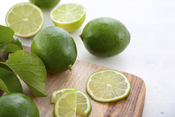 Limes on chopping board.