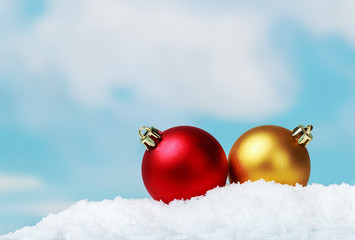 Christmas balls on the snow the background