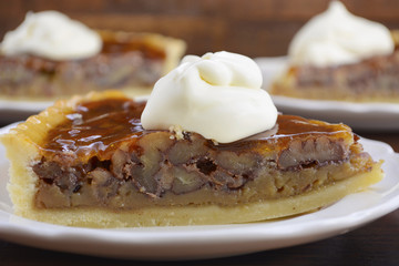 Pecan pie on dark wood background.