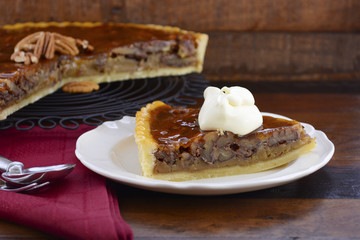 Pecan pie on dark wood background.