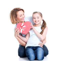happy mother and young daughter hold gift for birthday