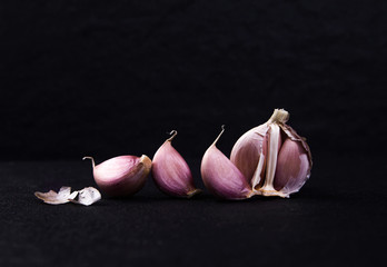  a still life arrangement of Three whole garlic bulbs grouped 