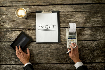 Top view of an auditor making calculations