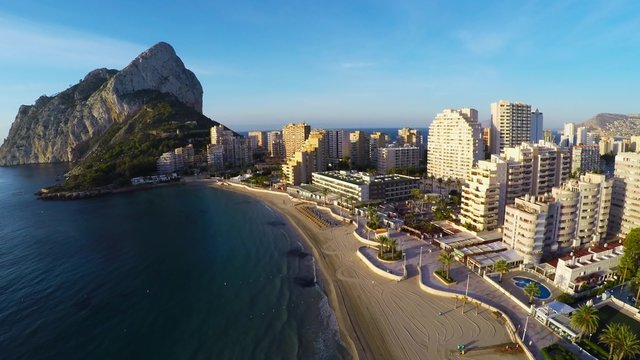 Aerial view of Calpe, Costa Blanca during the day. Popular summer resort in Spain with mediterranean sea and Las Salinas lake, mountains at the background, skyscrapers - hotels, apartments.
