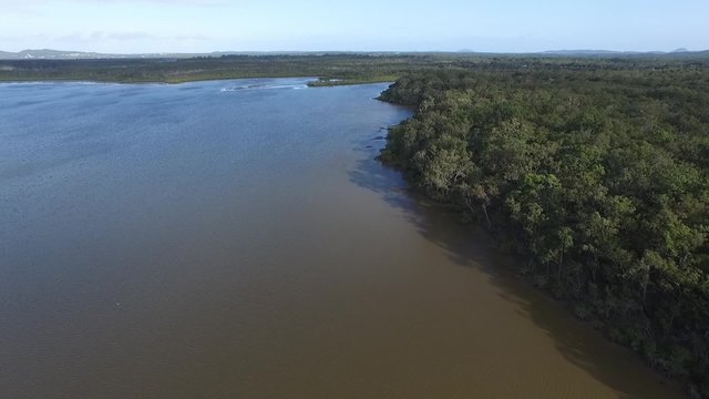 Aerial footage views of Queensland Tourism hot spot Noosa Heads and Noosa River, with clean blue pristine tropical water. Featuring boats, moorings, wetlands, sandbars, tourists and holiday makers.