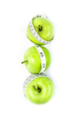 green apple with Measuring tape  in diet concept 