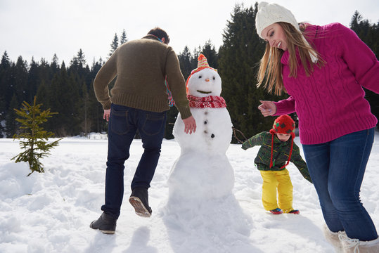happy family building snowman