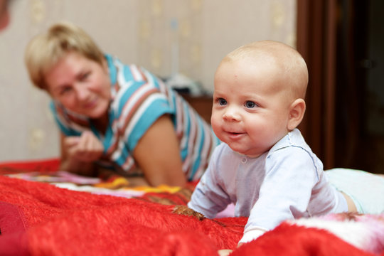 Smiling baby with his grandmother