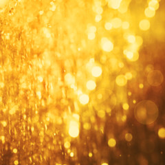 Abstract blur of gold color bokeh lighting as background