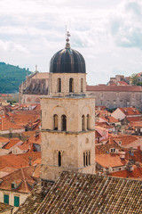 Fototapeta na wymiar Church tower and red roofs in old town Dubrovnik, Croatia, UNESCO site, panoramic view 