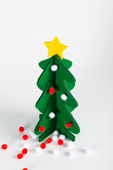 Small green Christmas tree with a golden star decoration isolate