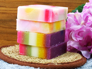 fruit soap with bath items on wooden background