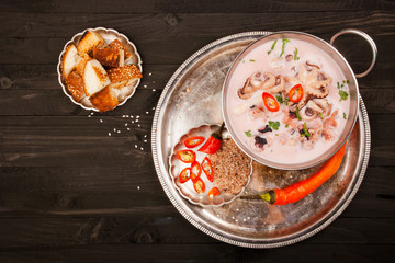 Soup from seafood: octopus, shrimp, mussels, squid. Top view.