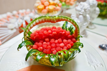 decorated watermelon with candies and other sweets on wedding re