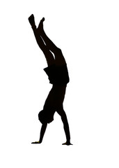 The isolate silhouette of a young man standing on hands