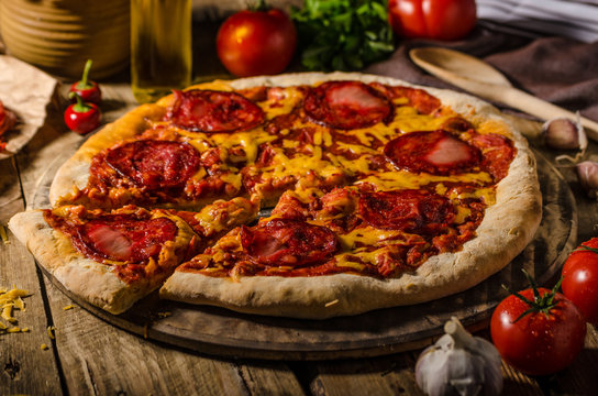 Rustic salami pizza with cheddar cheese and chorizo
