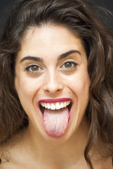 Portrait of Beautiful Young Woman with her tongue out