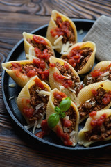 Italian conchiglioni stuffed with bolognese sauce, closeup