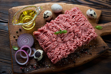 Raw beef mincemeat with seasonings, olive oil and quail eggs
