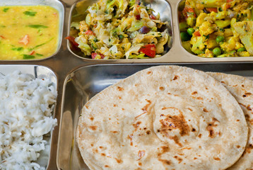 Tray with Indian dish thali, subji, rice and chapati bread